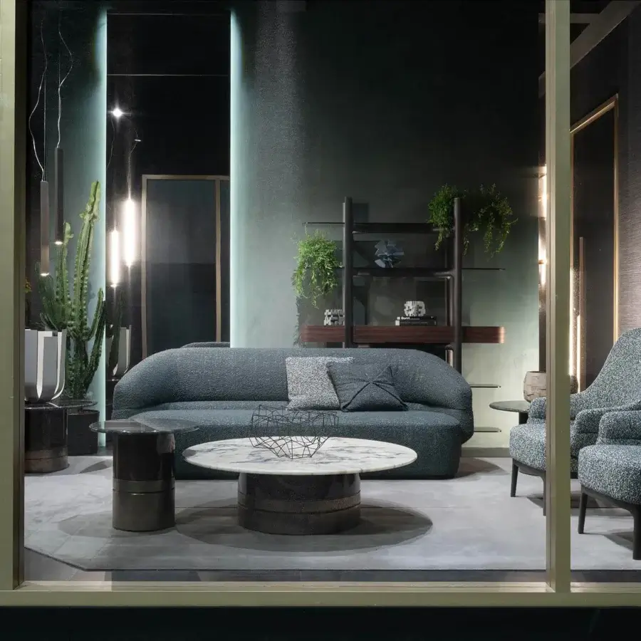 Elegant Zanaboni Alma sofa upholstered in subtly textured dark gray-blue textile with a refined grey stained ash wood base