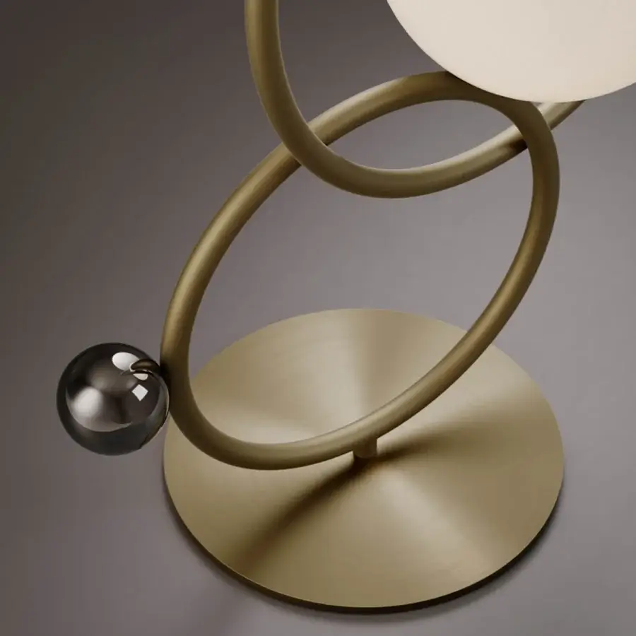 Distinguished VENICEM Zoe table lamp with intersecting light burnished brass rings and Murano blown glass diffuser in black nickel accents
