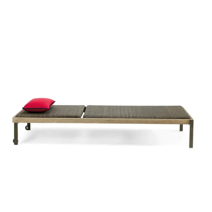 Elegant Ethimo Allaperto lounger crafted with matte wood and woven synthetic material in pink with dark blue trim