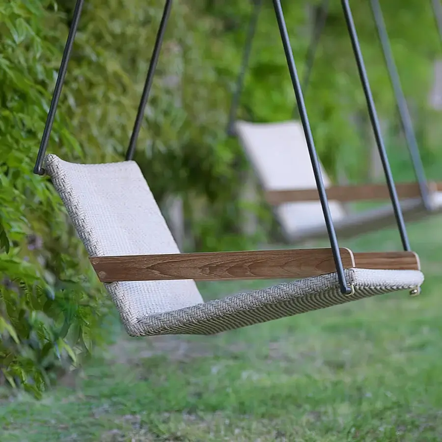 Architectural Ethimo Allaperto Swing lounge with dark gray metal frame and light gray woven textile complemented by warm brown wood