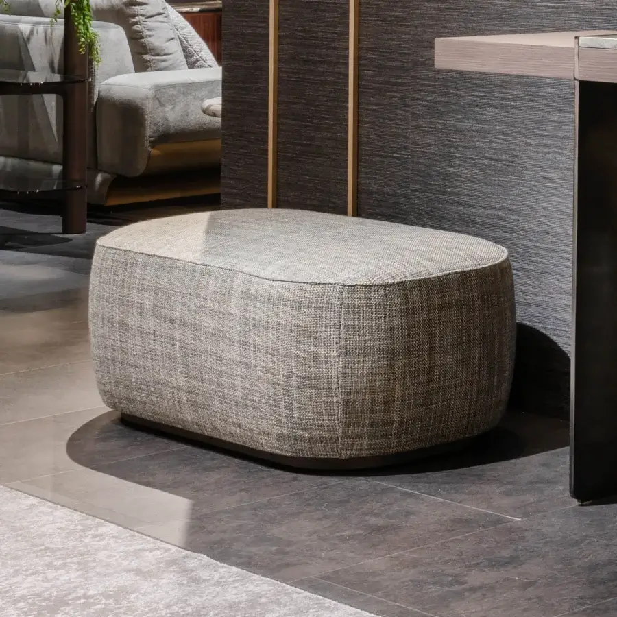 Superior Zanaboni Alma ottoman with gray textile upholstery and gray-stained ash base offers a rounded asymmetrical form