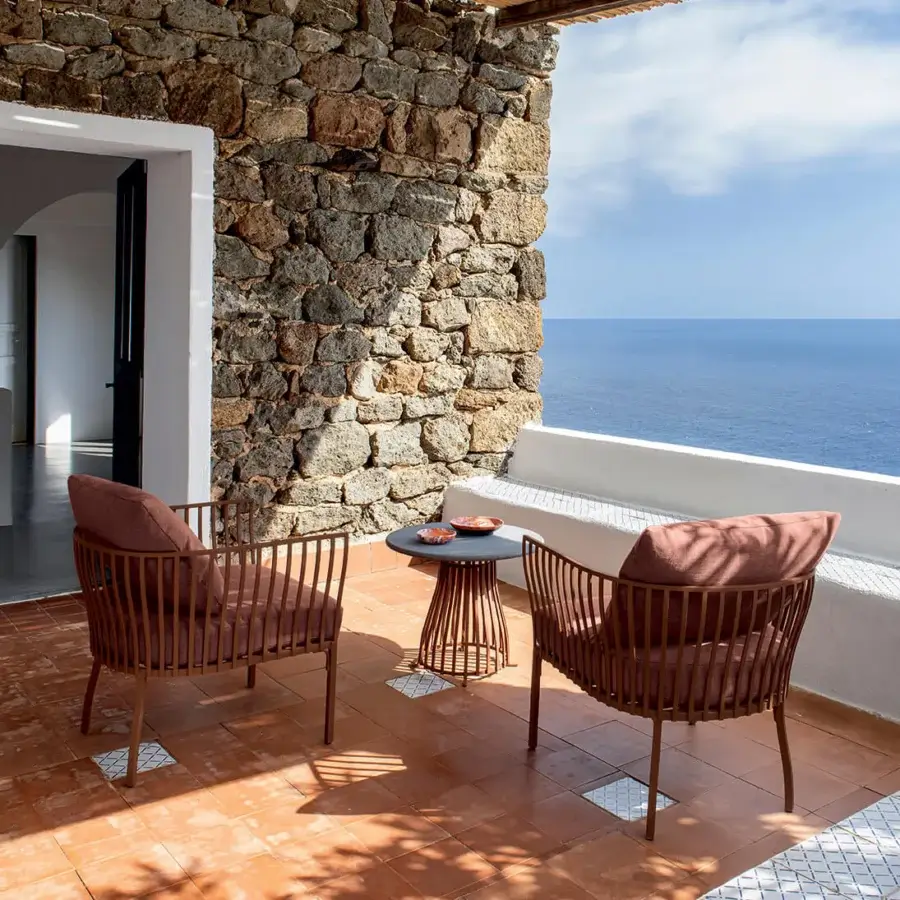Elegant Ethimo Venexia lounge chair with muted rose woven textile and matte aluminum frame