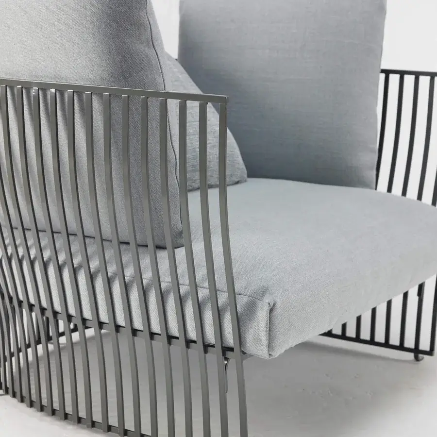 Exceptional Ethimo Venexia lounge chair with a dark gray aluminum structure and light gray cushions offering weightless luxury