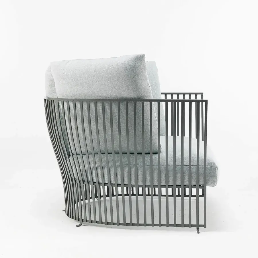 Sophisticated Ethimo Venexia lounge chair with enveloping form and generous cushions in light grey textile with matte grey aluminum slats