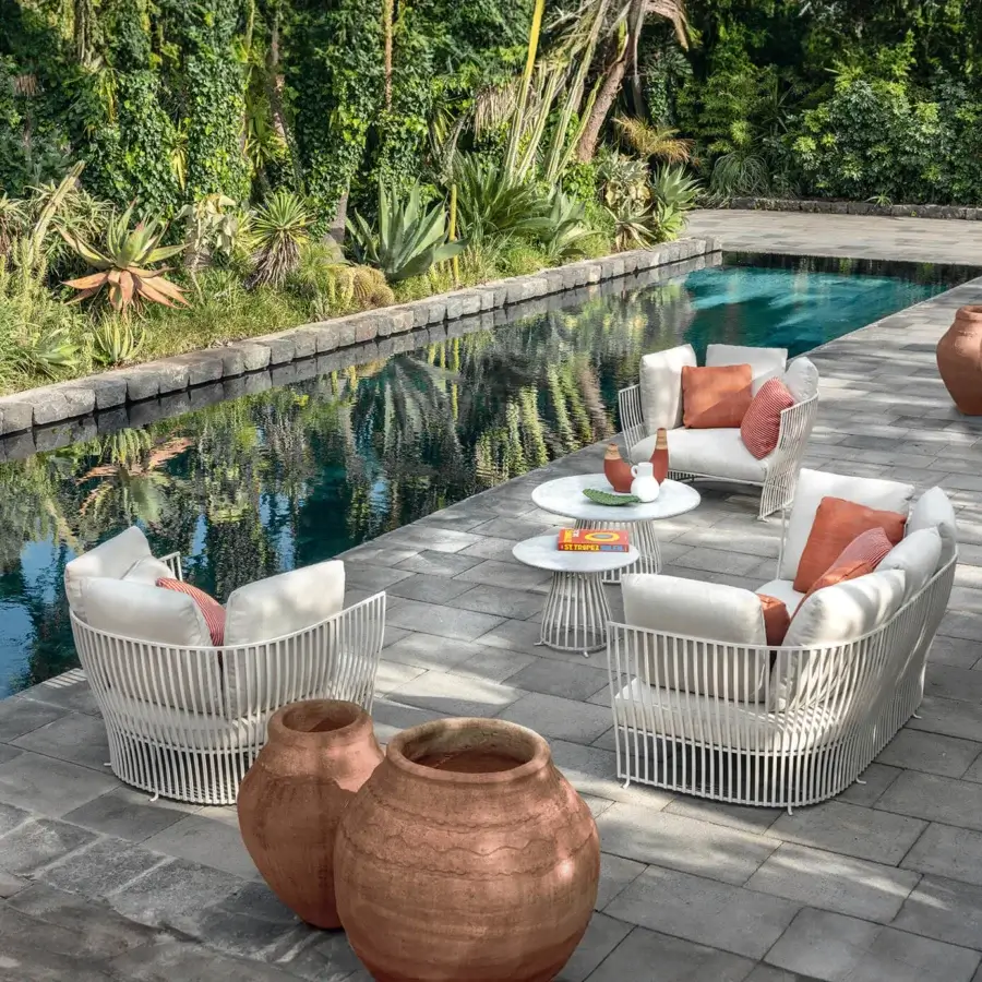 Lavish Ethimo Venexia lounge chair built with woven aluminum slats and plush terracotta cream cushions