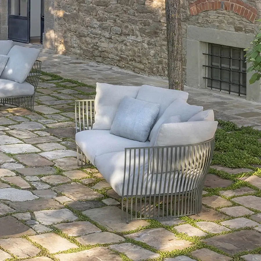 Exceptional Ethimo Venexia sofa with a refined aluminum frame and light gray cushions offering relaxed al fresco living