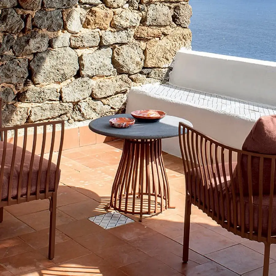 Distinguished Ethimo Venexia coffee table with a muted gray stone tabletop and bronze-toned aluminum slats crafted in Italy