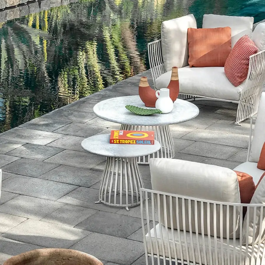 Distinguished Ethimo Venexia coffee table with a circular glossy glass top and matte gray aluminum base