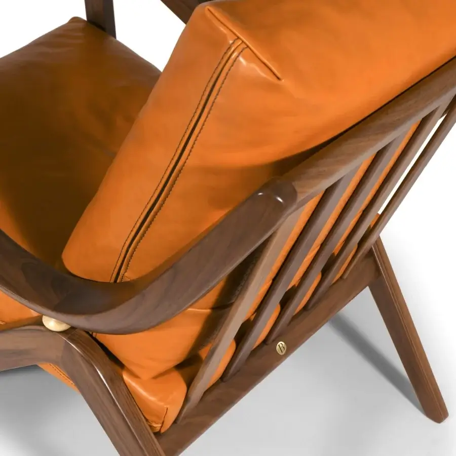 Distinguished Borzalino Taylor armchair with saturated orange-brown leather upholstery and hand-carved canaletto walnut frame