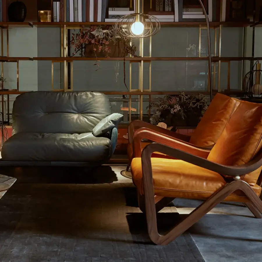 Elegant Borzalino Taylor armchair with supple tan leather upholstery and hand-carved canaletto walnut frame in a natural finish