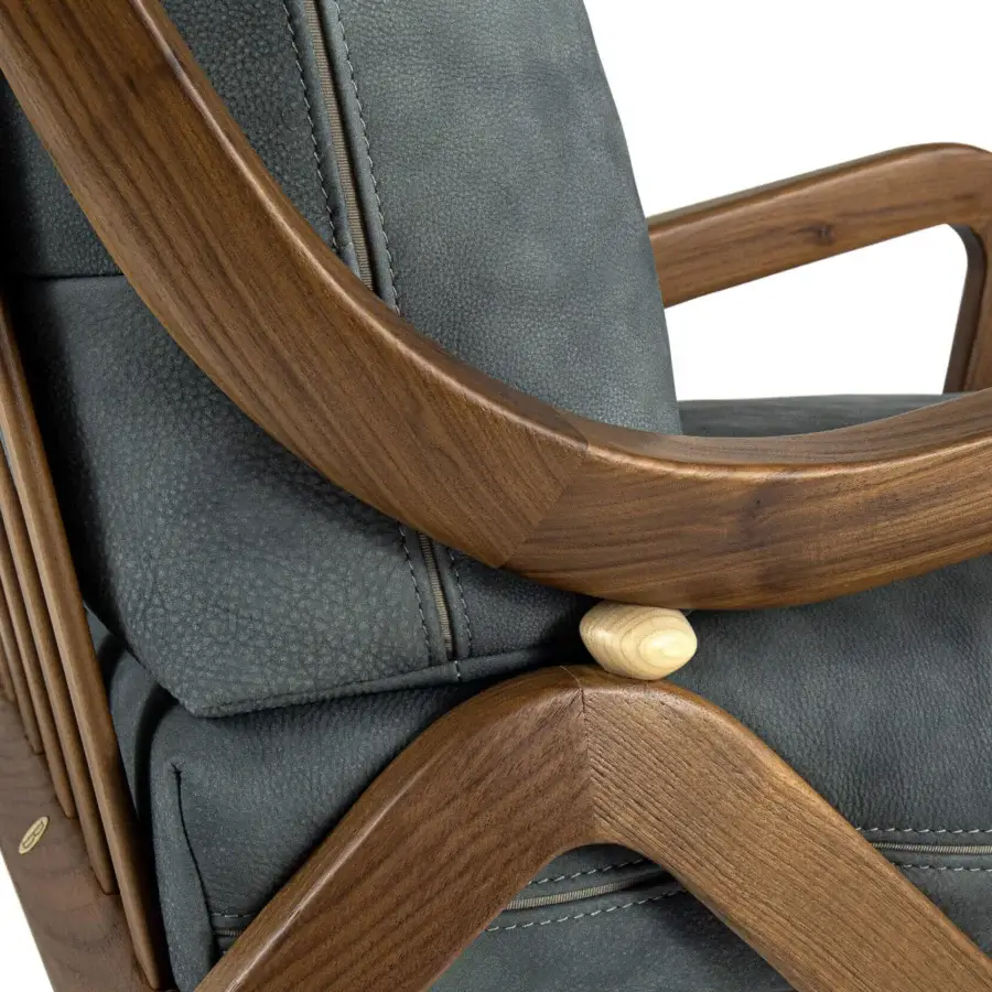 Elegant Borzalino Taylor armchair with sinuous hand-carved canaletto walnut frame in a natural finish and dark gray cushions