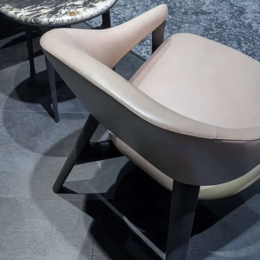 Distinguished Zanaboni Egle lounge chair built with sculpted wood and two-tone leather upholstery in a matte dark stained finish