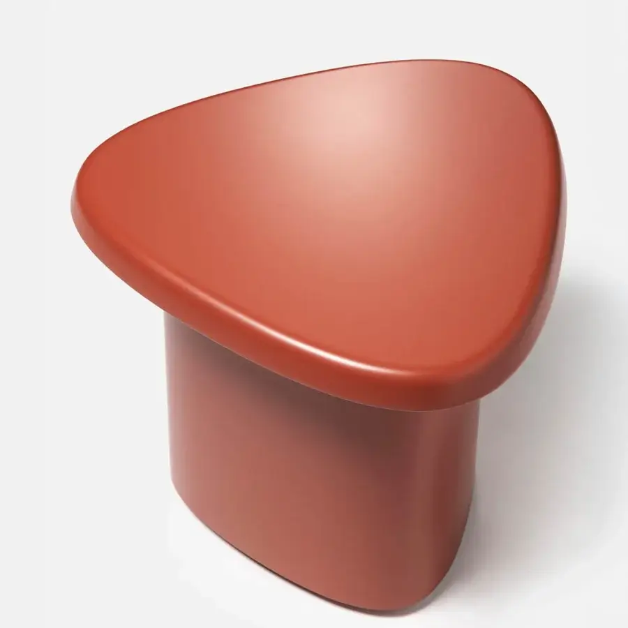 Distinctive Carpanese Home Bitt side table in muted terracotta with smooth matte synthetic material and unified organic form