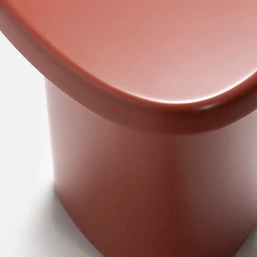 Elegant Carpanese Home Bitt side table in terracotta with glossy rounded form and seamless construction