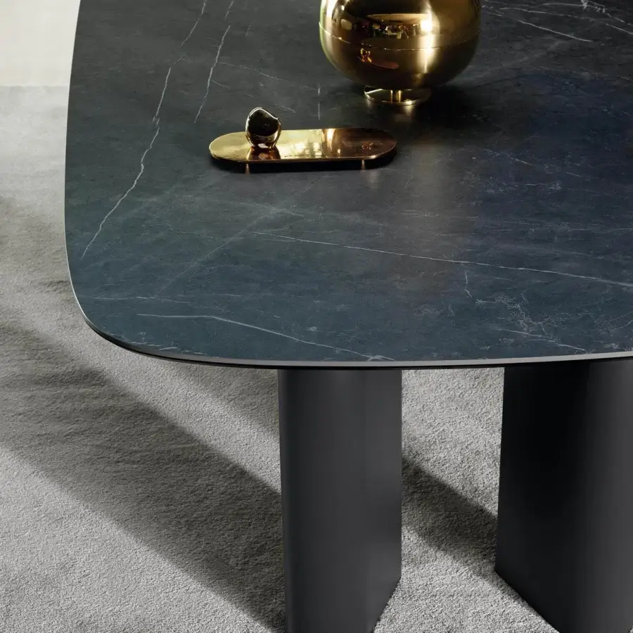 Elegant Bonaldo Geometric table with shaped top in dark marble-like material and dark wood teardrop legs with metal profile