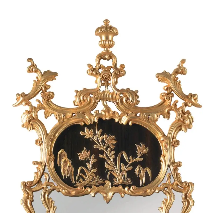 Distinguished Armando Rho A1378 mirror crafted in gold leaf with ebony exhibiting raised gilded chinoiserie paintings