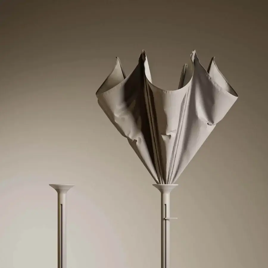 Distinguished Royal Botania Anamon sunshade with draped textile and slender metal stem in a light beige matte finish