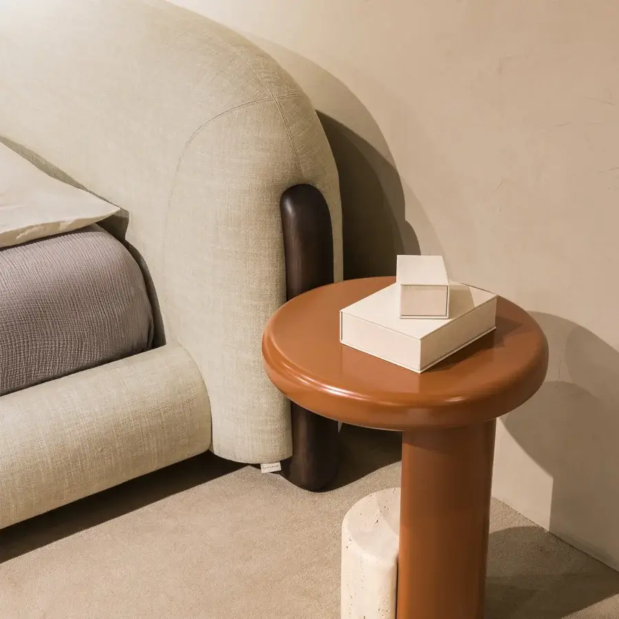 Exceptional Carpanese Home Milestone side table with curved cylindrical form and reddish-brown lacquered surface