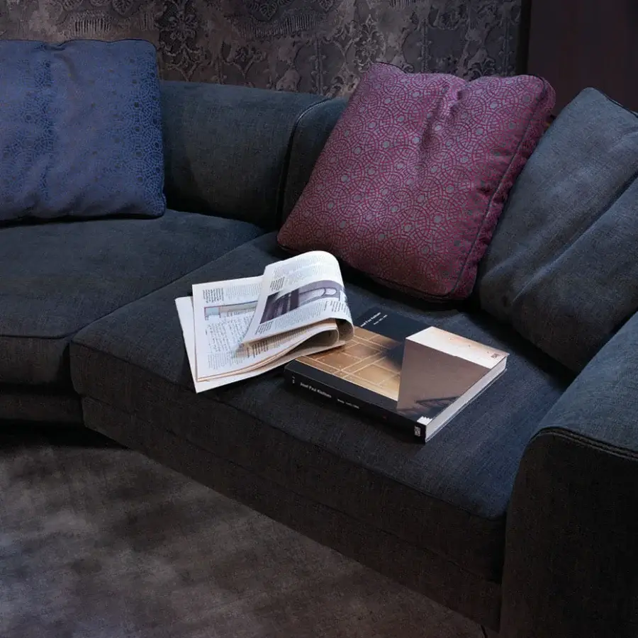 Elegant Borzalino Franklin L sectional with dark gray textile upholstery and plush burgundy, dark blue, and gray cushions