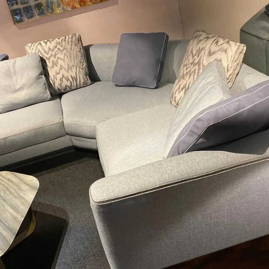Luxury Borzalino Franklin L sectional with textured medium gray textile upholstery and lavender throw pillows