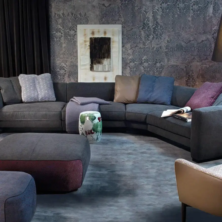 Superior Borzalino Franklin L sectional with dark gray textile upholstery, solid wood structure and plush cushions in blue, burgundy, tan