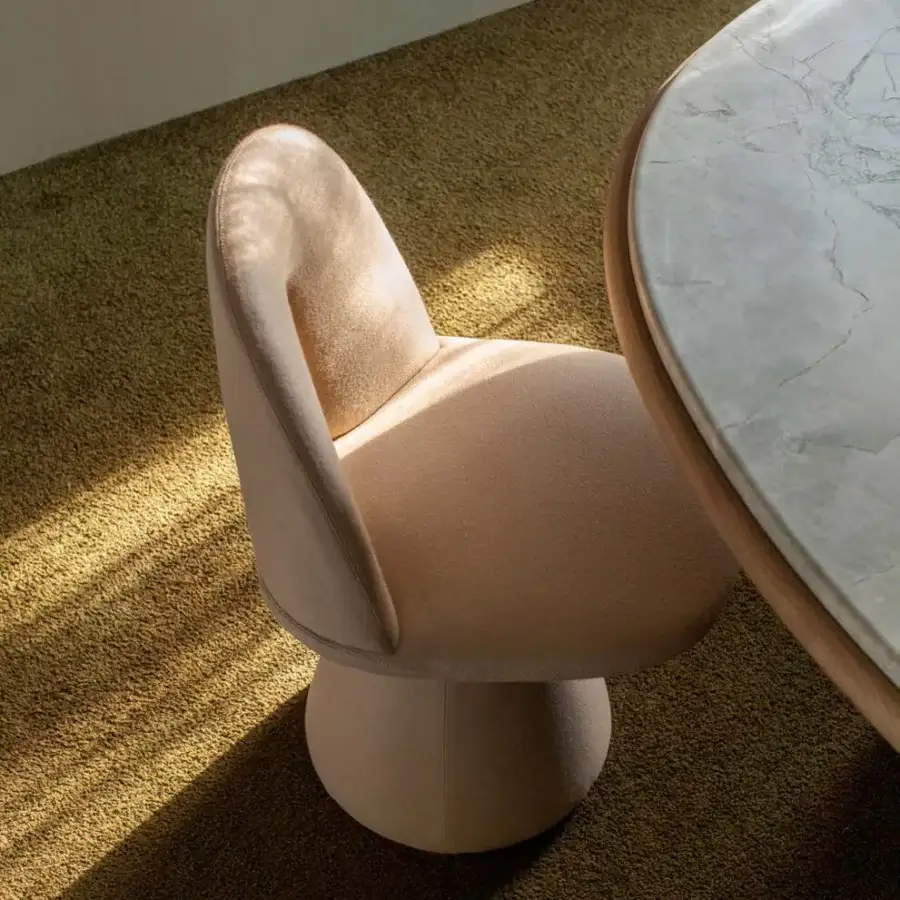 Distinctive Carpanese Home Bill chair crafted with wood and fully upholstered in soft dusty rose textile, exhibiting architectural forms