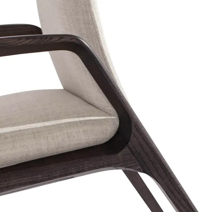 Elegant Carpanese Home Birkin armchair with gently curved form and muted beige textile upholstery in dark satin finished solid ash wood