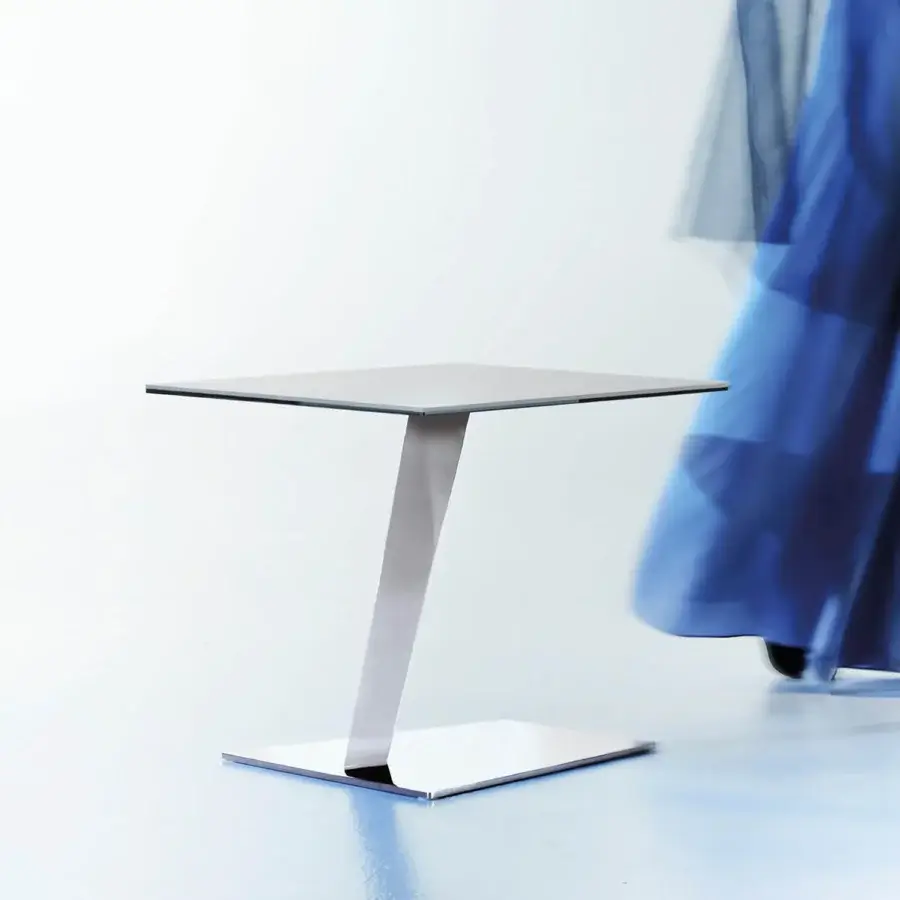Distinguished Naos Calypso side table with smooth glass tabletop and polished neutral gray metal base