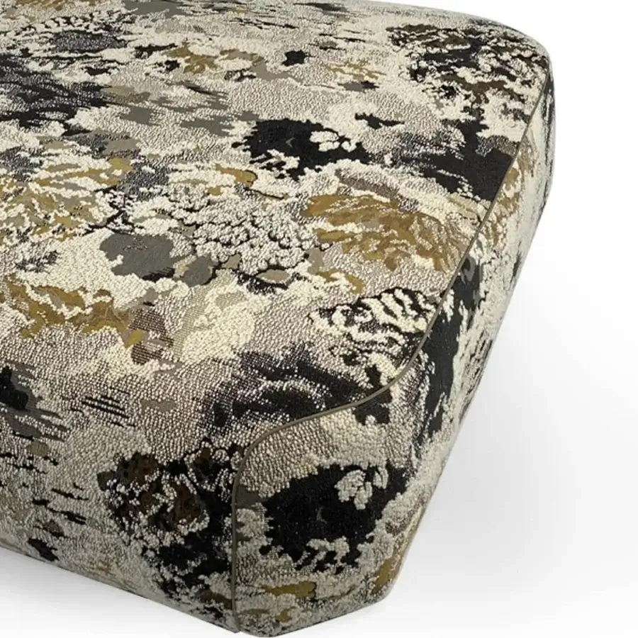 Elegant Borzalino Franklin ottoman upholstered in textured cream, gray, and gold textile with lacquered wood feet