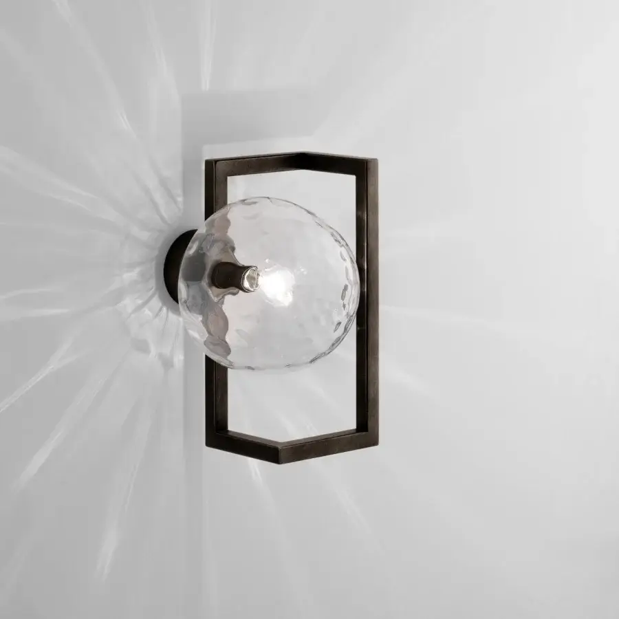 Captivating Vistosi Globose wall lamp crafted in dark metal with a luminous hand-blown glass diffuser