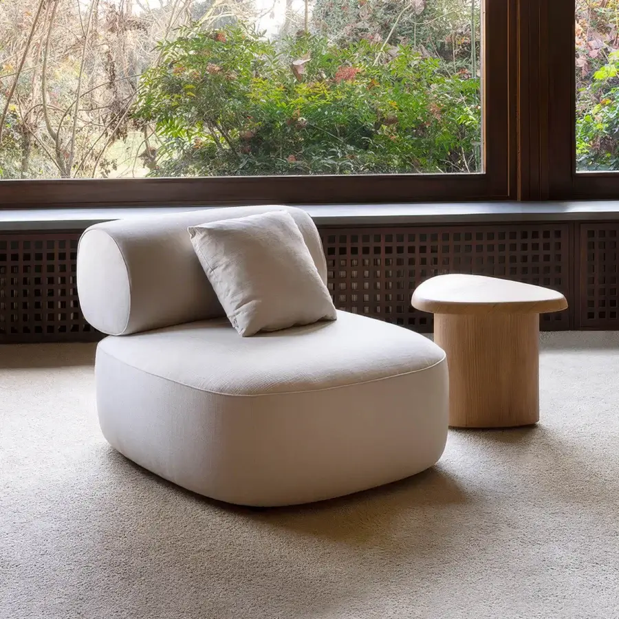 Elegant Carpanese Home Slow Lounge chair upholstered in muted beige textile with visible ash wood finish
