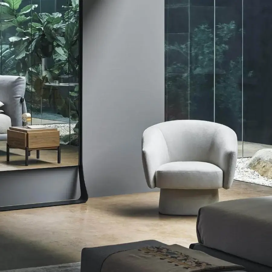 Elegant Bonaldo Bruno lounge chair with curved shapes and generous padding in a light neutral textile with matte finish