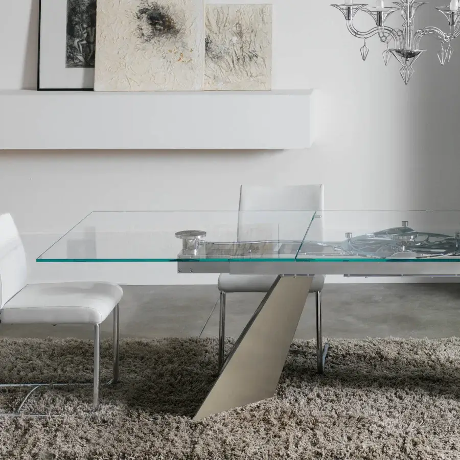 Sophisticated Naos Galax extendable dining table with clear glass, a chromed steel base, and teal painted central support leg