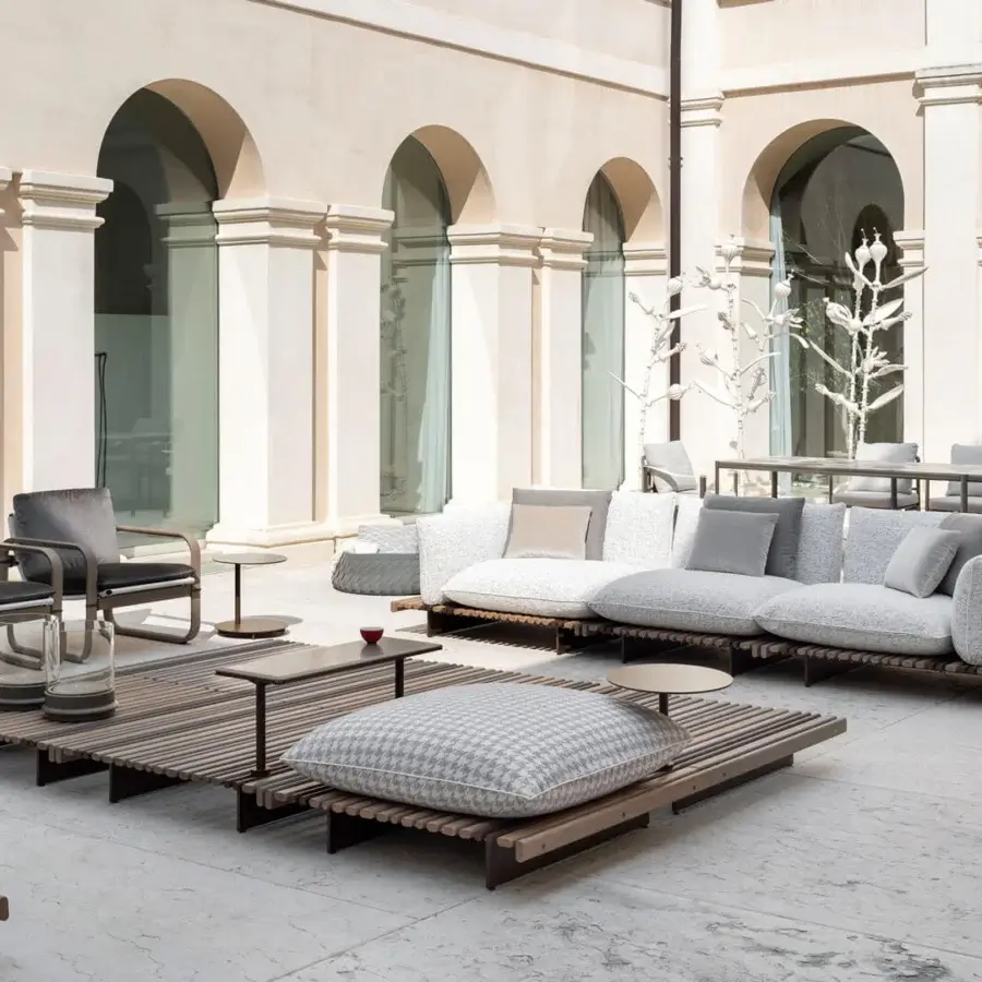 Exceptional Giorgetti Aldìa armchair crafted with sleek metal and sculptural birch plywood in a satin finish with light gray waterproof fabric