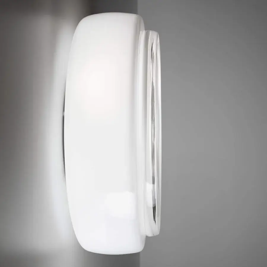 Elegant Vistosi Bot wall lamp crafted in glossy white glass creating radiant localized illumination with a minimalist aesthetic