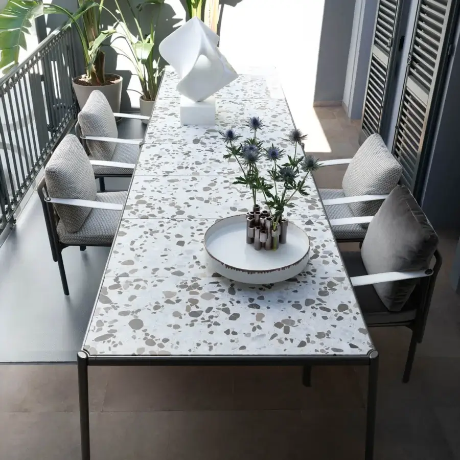 Superior Giorgetti Aldìa table with a substantial terrazzo tabletop and sleek metal frame built with a polished surface