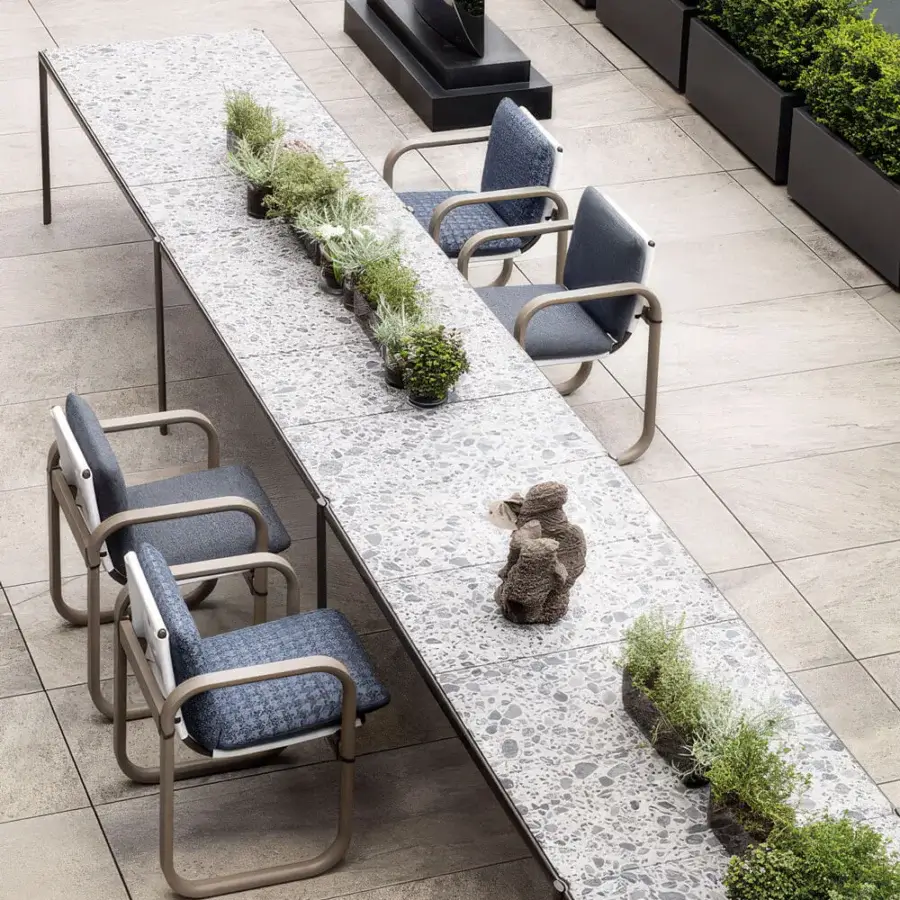 Superior Giorgetti Aldìa table with a speckled grey composite tabletop and sleek dark metal legs