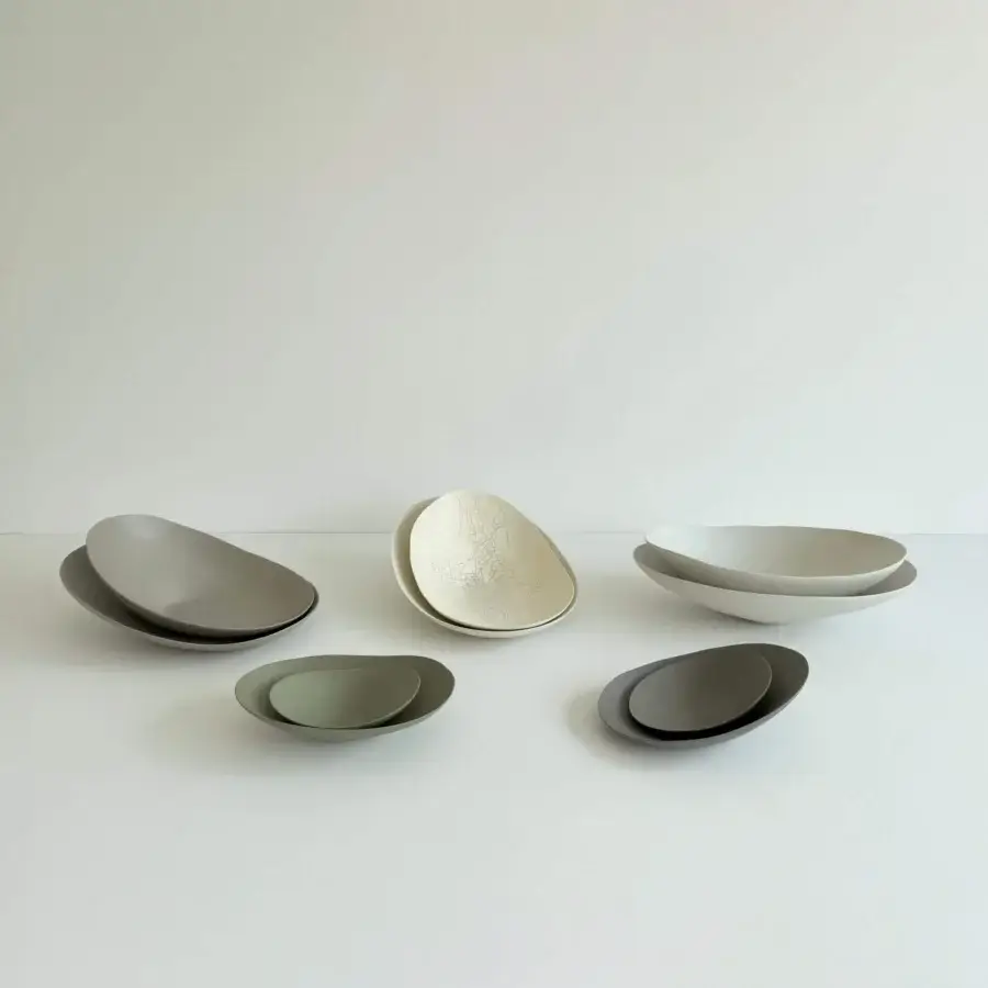 Distinguished Rina Menardi Baccelli centerpiece crafted in baked clay with a soft grey-green hue and matte finish
