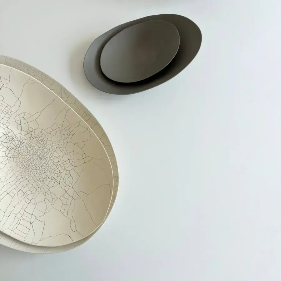 Distinguished Rina Menardi Baccelli centerpiece crafted from baked clay with dark crackled lines and a matte finish