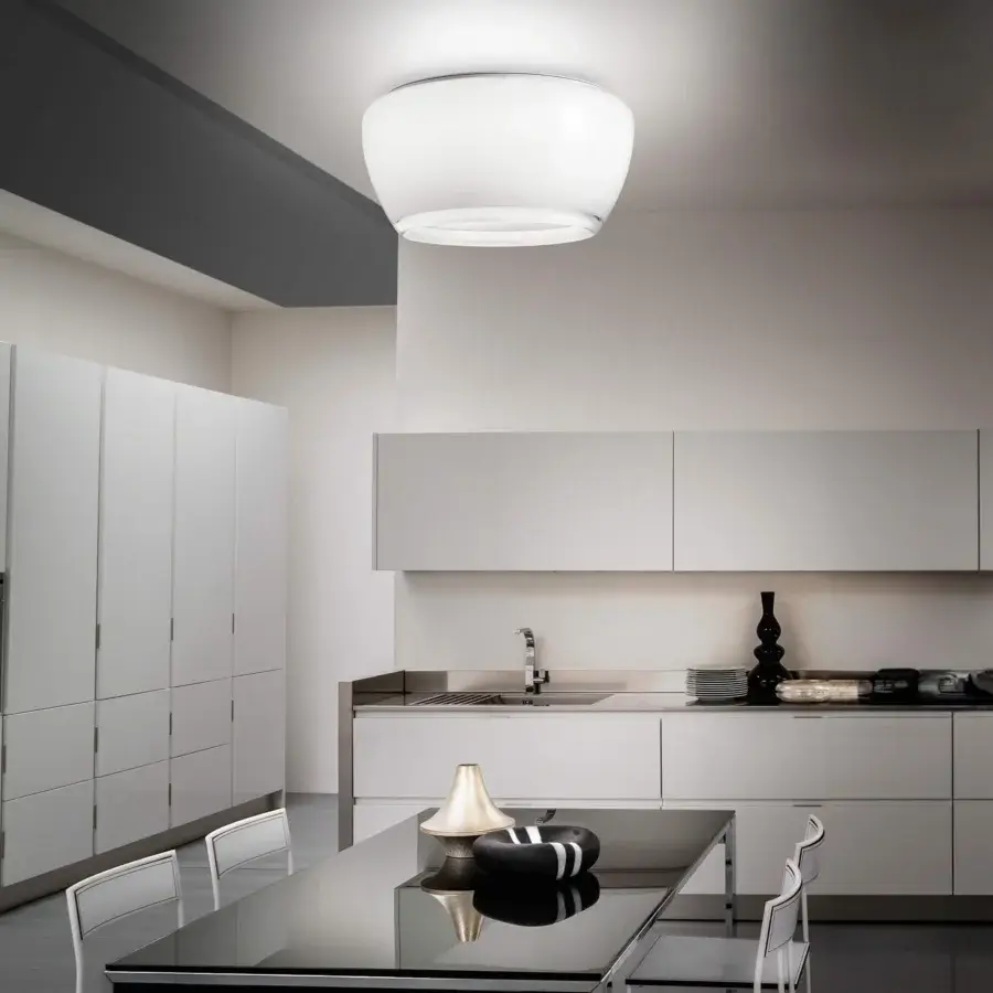 Elegant Vistosi Implode ceiling lamp crafted in multi-layered glass with gradation between white and transparent crystal and satin metallic perimeter