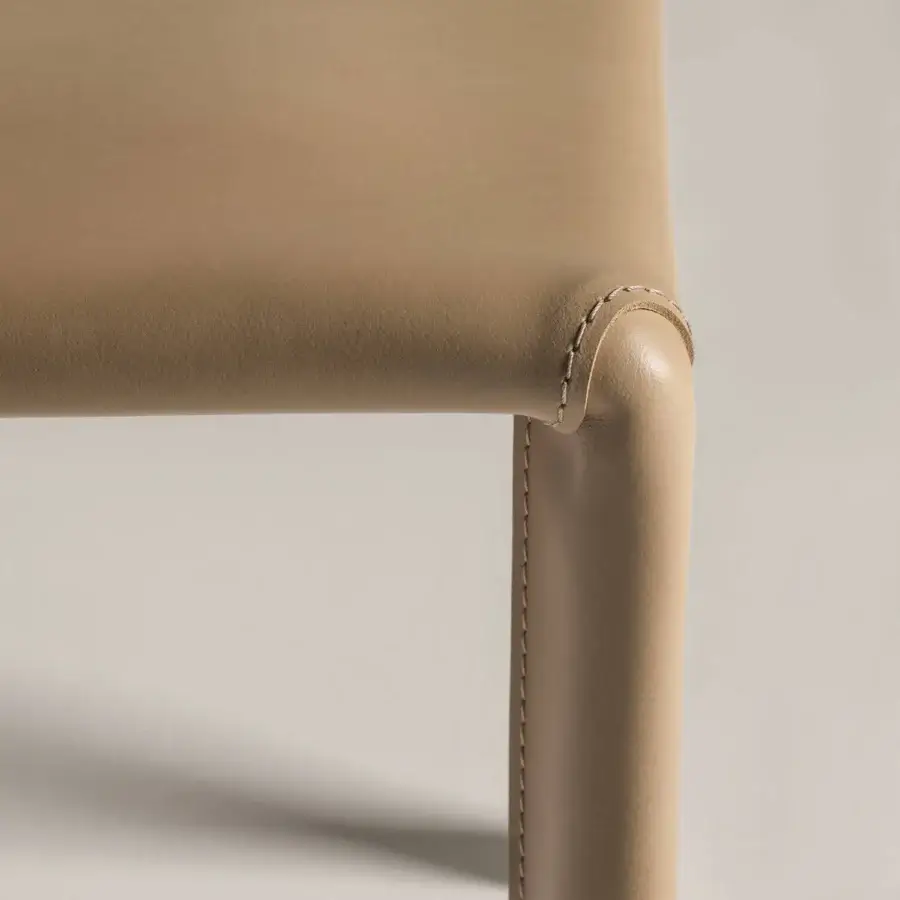 Captivating Frag Blyn dining chair with full saddle leather upholstery and sleek beige steel structure