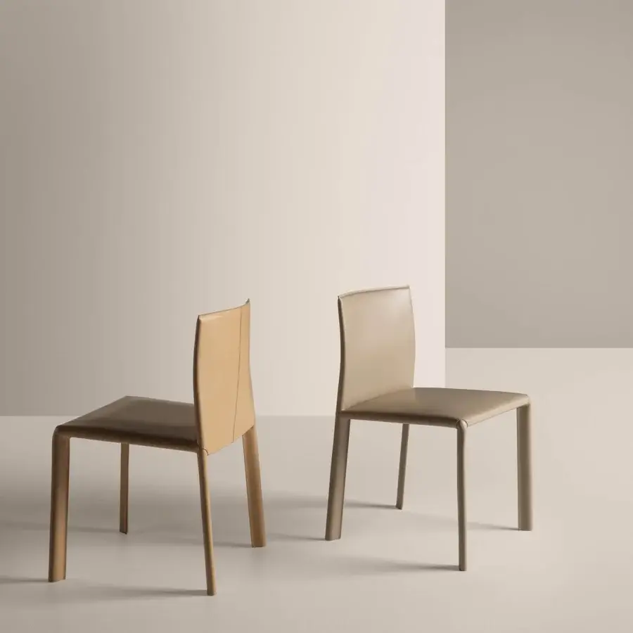 Exclusive Frag Blyn dining chair with full saddle leather upholstery and refined steel structure in a muted tan finish
