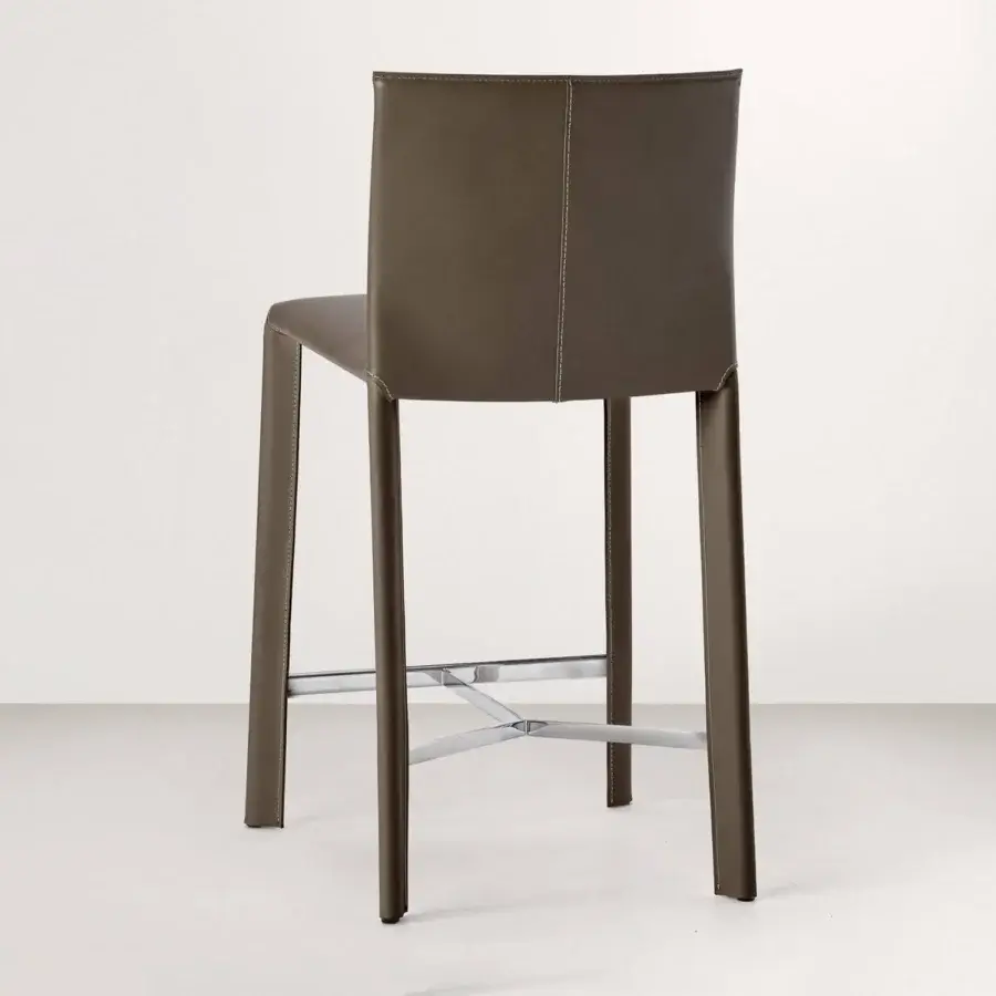 Superior Frag Blyn bar stool with full saddle leather upholstery and sleek steel structure, finished with a muted brownish-grey tone