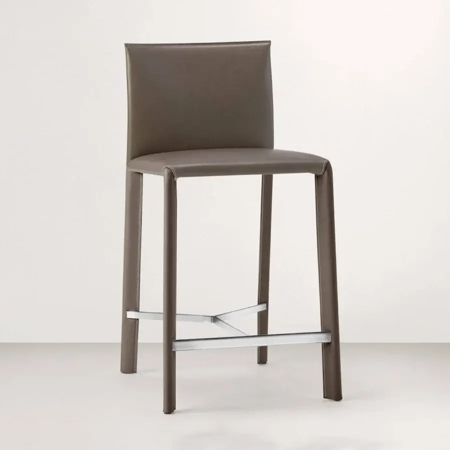 Elegant Frag Blyn bar stool with full saddle leather upholstery and brushed steel structure crafted with a smooth matte finish