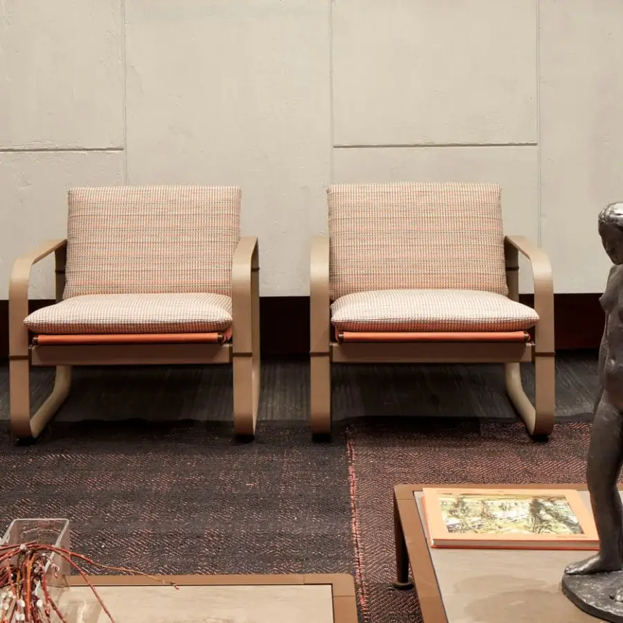 Distinguished Giorgetti Loop lounge chair with patterned beige, orange, and white textile upholstery and grey water-polished ash wood frame