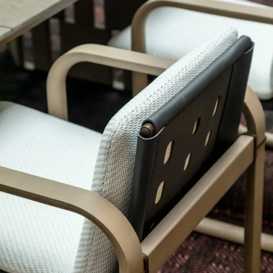 Superior Giorgetti Loop armchair with sculpted lines, grey water-polished ash wood and carob aluminum details upholstered in textured white herringbone fabric