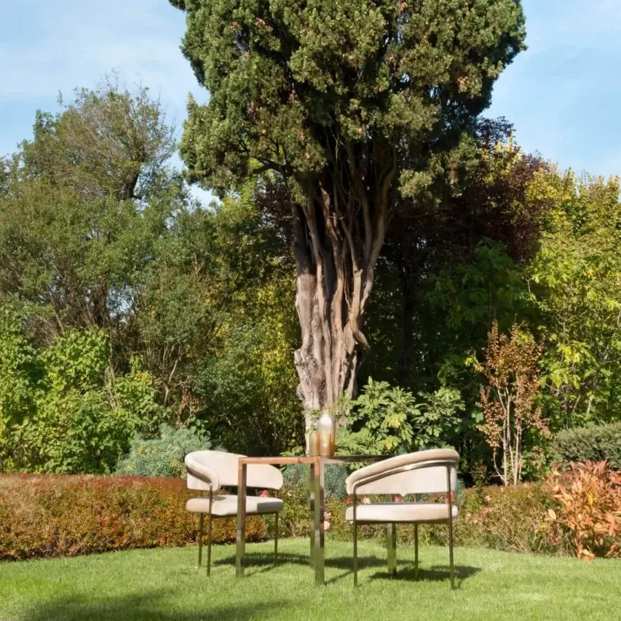 Superior Visionnaire Clem Outdoor armchair crafted with a squared brass pipe frame and light beige acrylic fiber upholstery