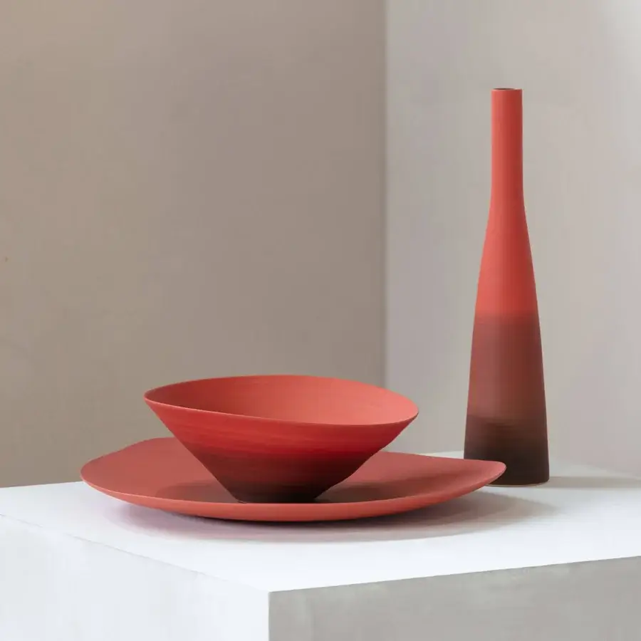 Exclusive Rina Menardi Campanelle centerpiece crafted from baked clay with a red-brown gradient and smooth matte finish