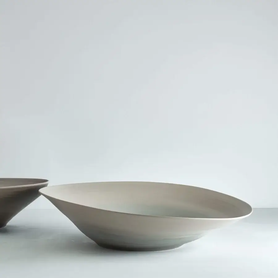 Distinguished Rina Menardi Campanelle plate centerpiece crafted from baked clay in a pale gray palette with tonal variations