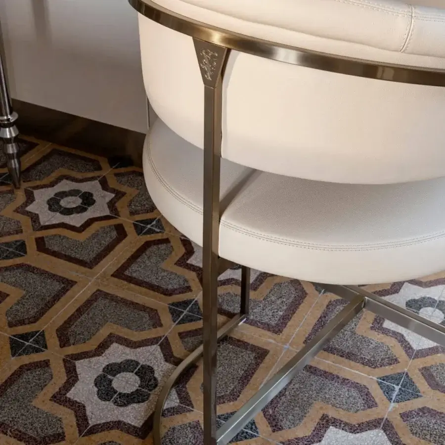 Distinguished Visionnaire Clem stool upholstered in refined off-white textile with a rigorously squared brass pipe frame